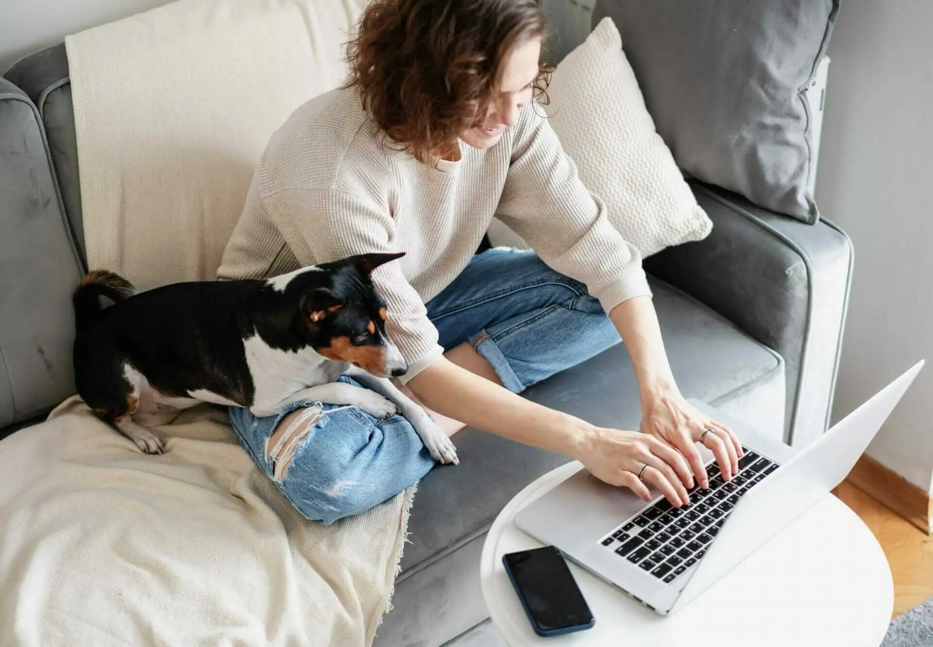 Writing blogs to increase your SEO - woman writing with dog in her lap