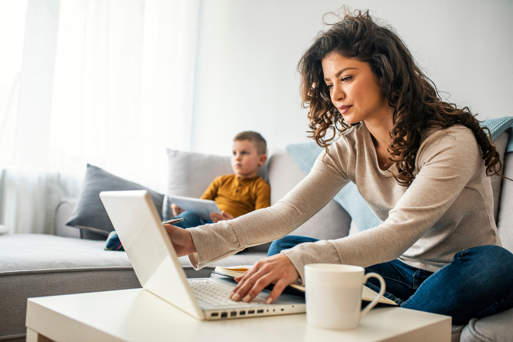 Woman at her computer in an article about the customer journey from Google Ad to becoming a therapy client.