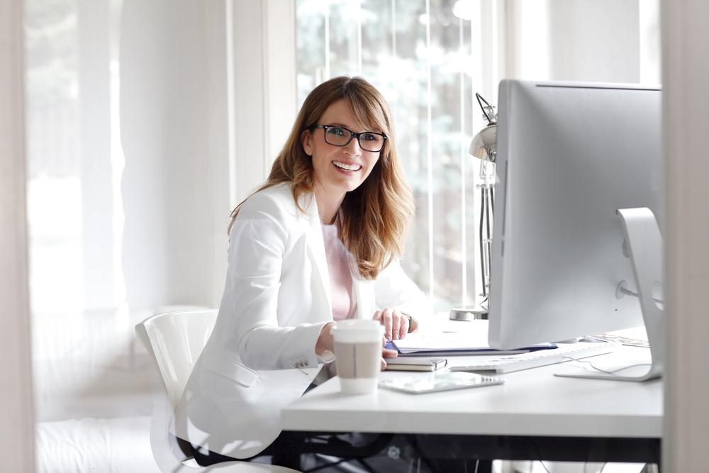 Woman at her computer in an article by Crownsville Media about Google Ad mistakes in 2025