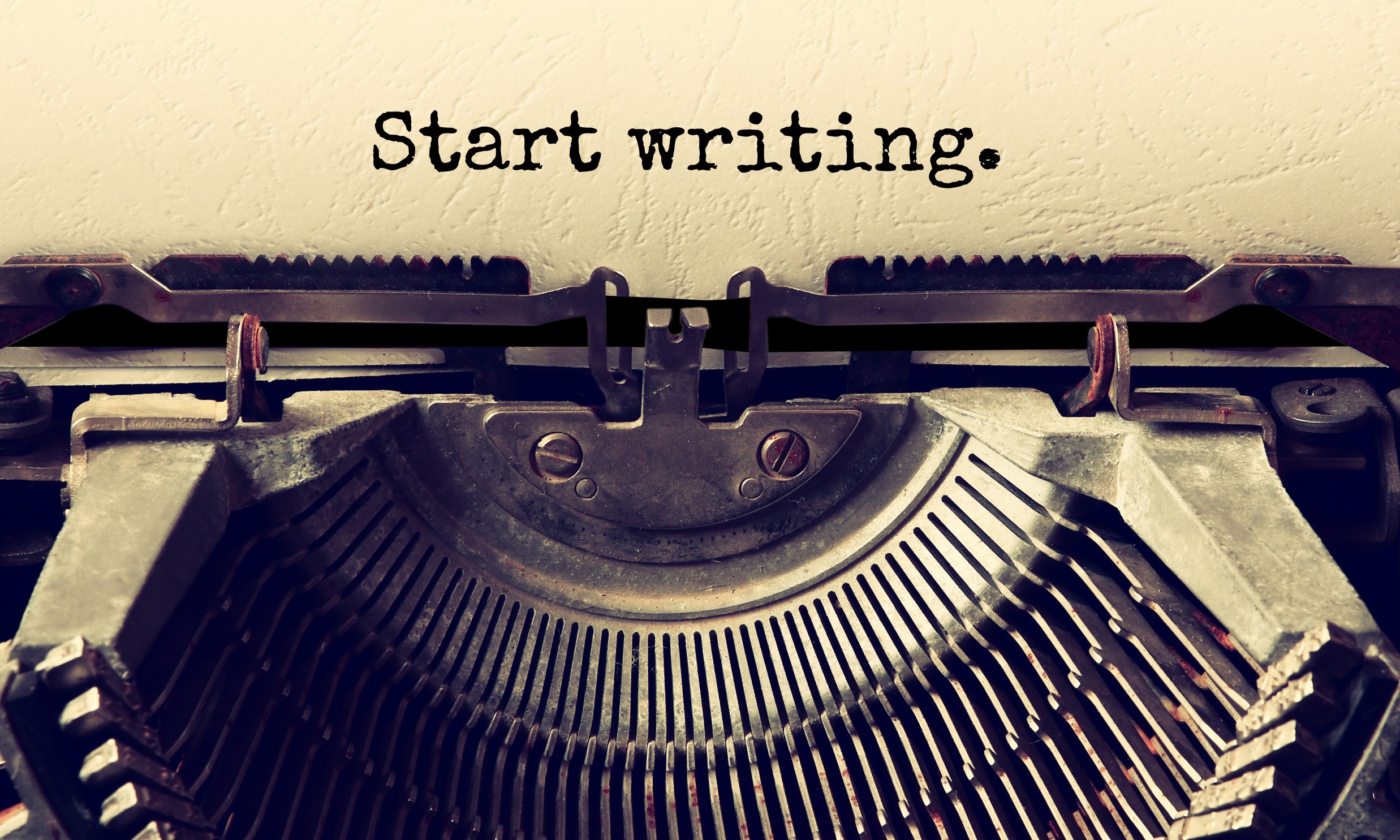 Old typewriter with the words start writing in an article on can AI writing hurt your SEO.