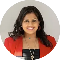 Smiling woman with dark hair in a red blazer circular crop