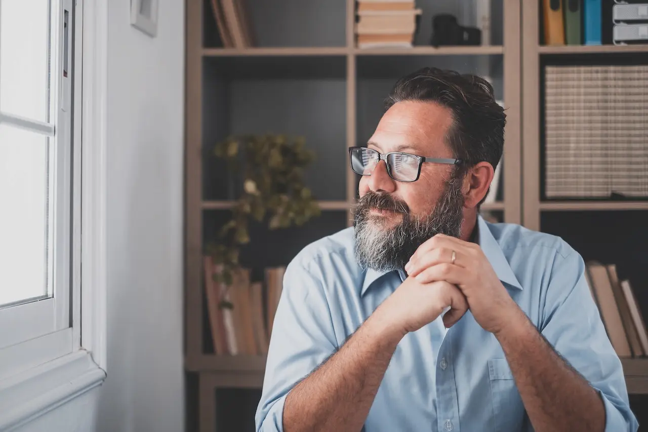 Man at his desk looking out the window
