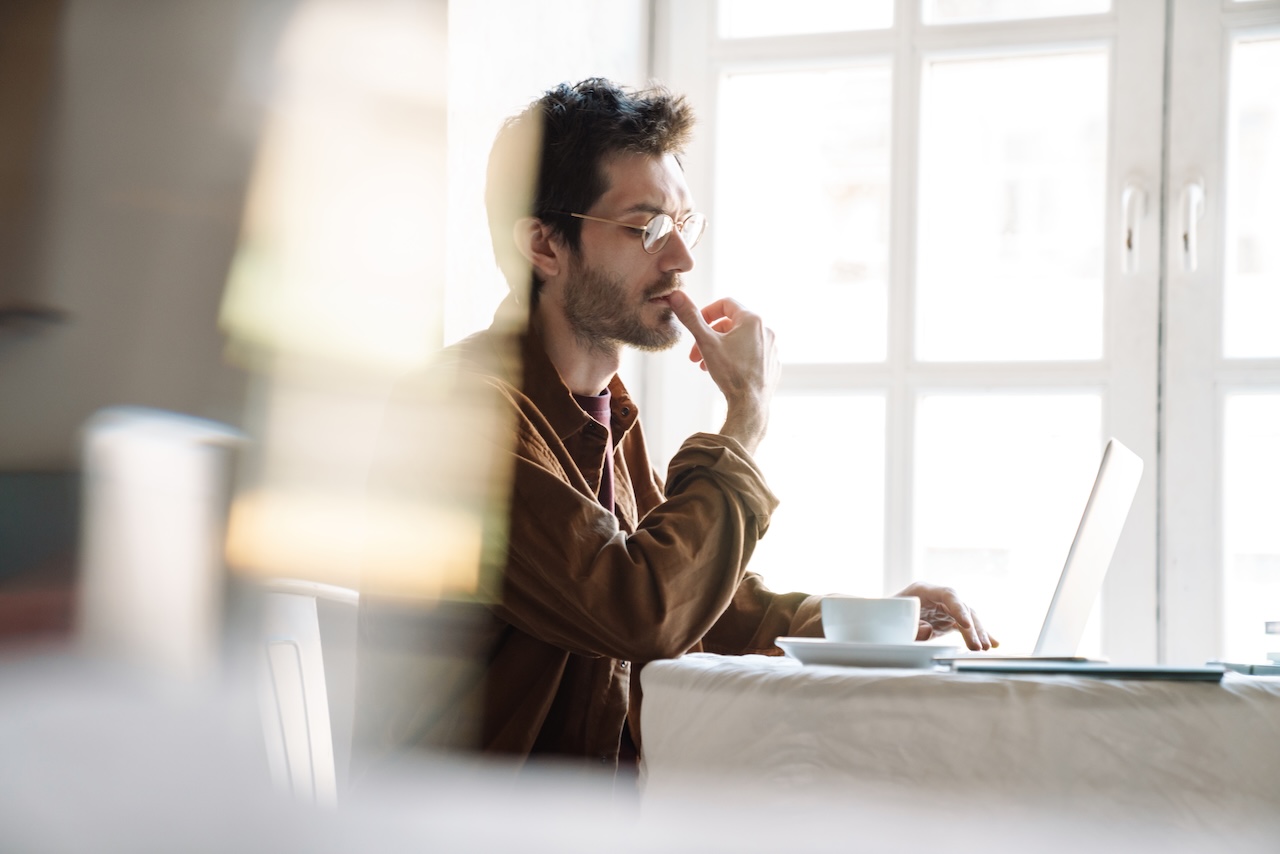 Image of serious man at his laptop trying to figure out how to recover his seo