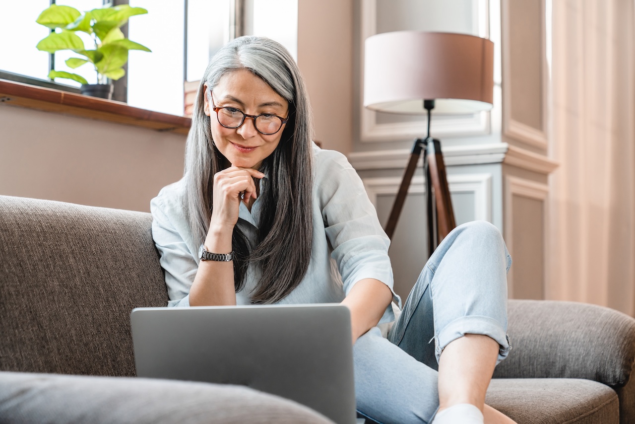 Cheerful mature woman therapist happy with her content creation and seo focused landing pages