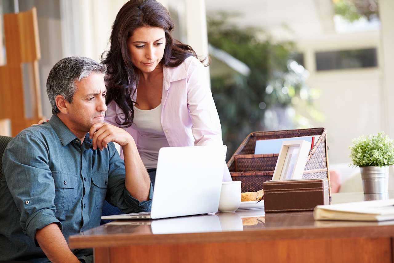 Worried hispanic couple at work trying to figure out their local seo