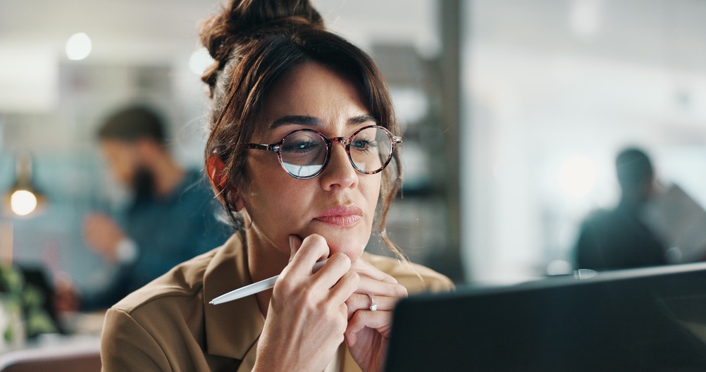 Woman thinking about her website and deciding what to keep in her redesign